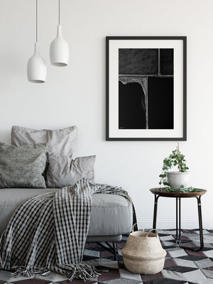 Black and white framed print on wall in black frame abstract