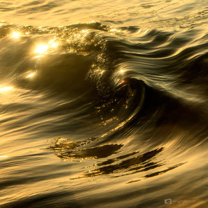 Black and golden wave breaking