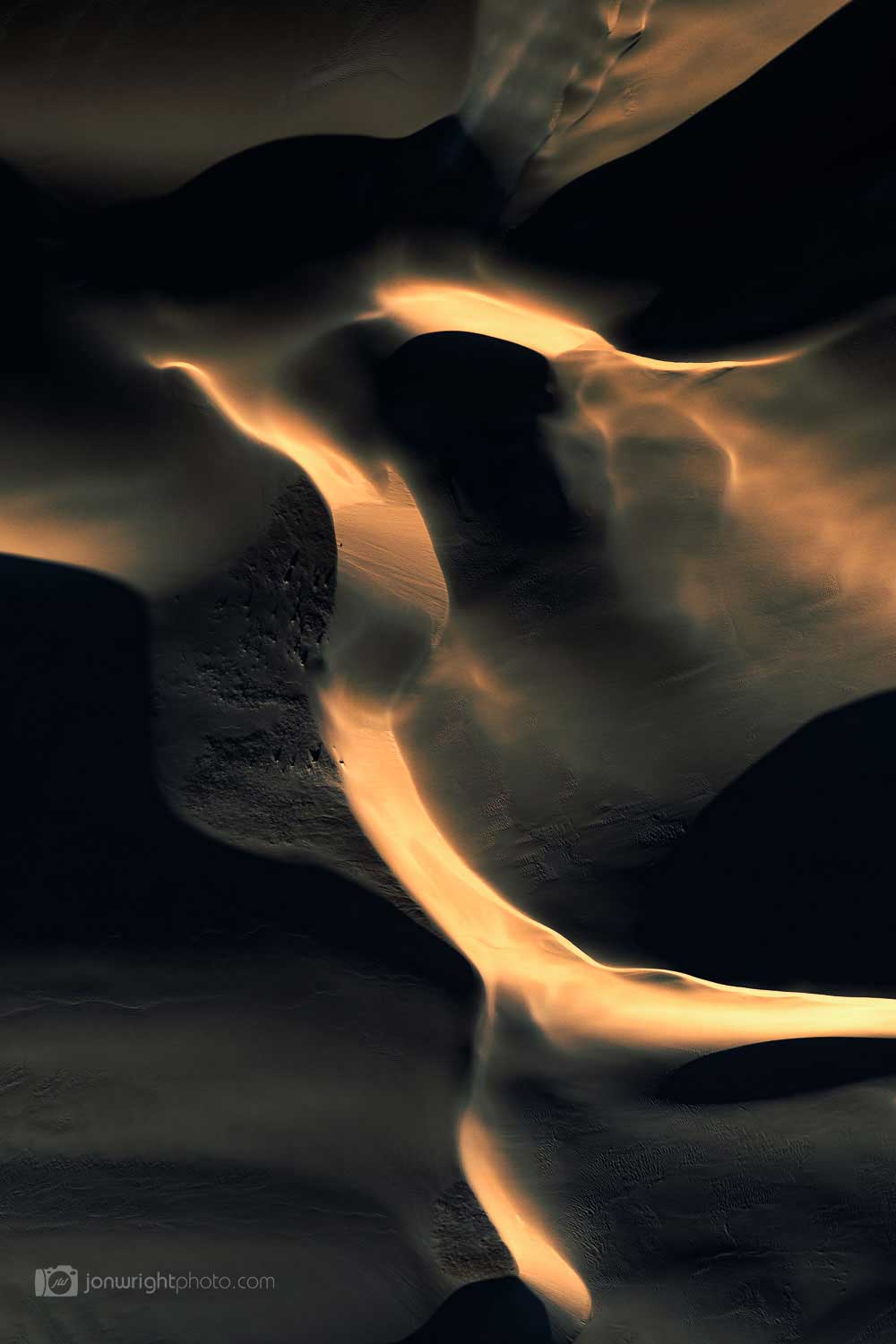 Sand dunes at sunset with dark shadows similar to an eagle
