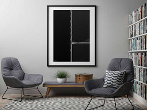 black and white abstract photographic print framed in black frame on wall