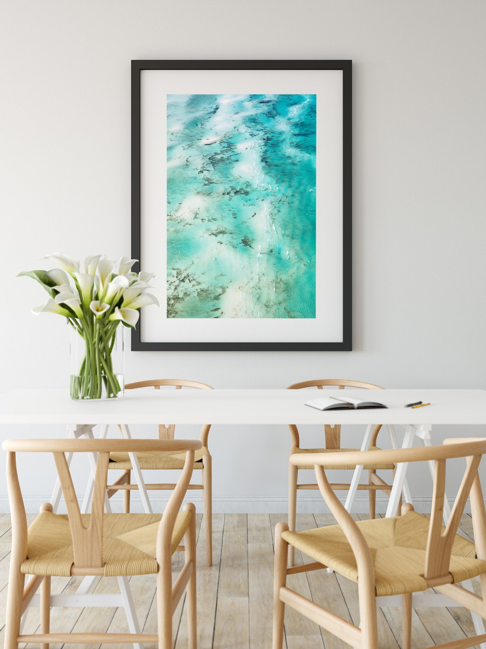 Turqoiuse wall art with white frame of abstract aerial art