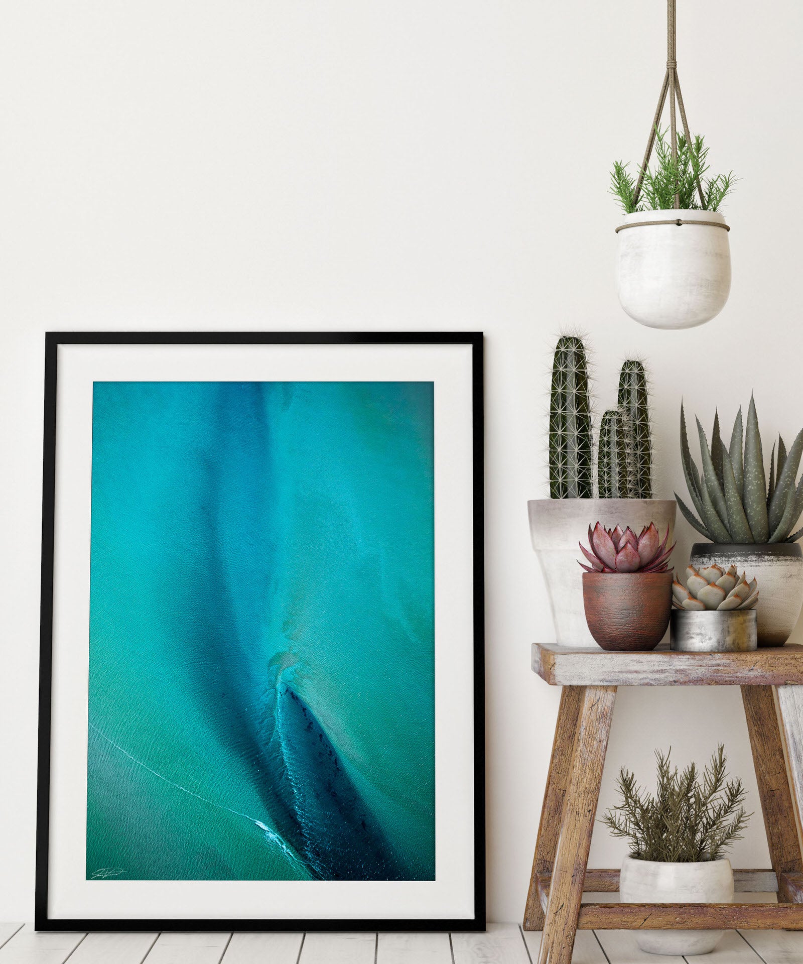 Blue and green abstract aerial wall art in black frame and modern styling