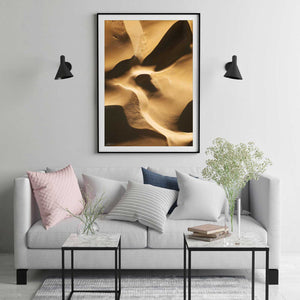 Abstract aerial print of sand dunes with golden tones framed in black