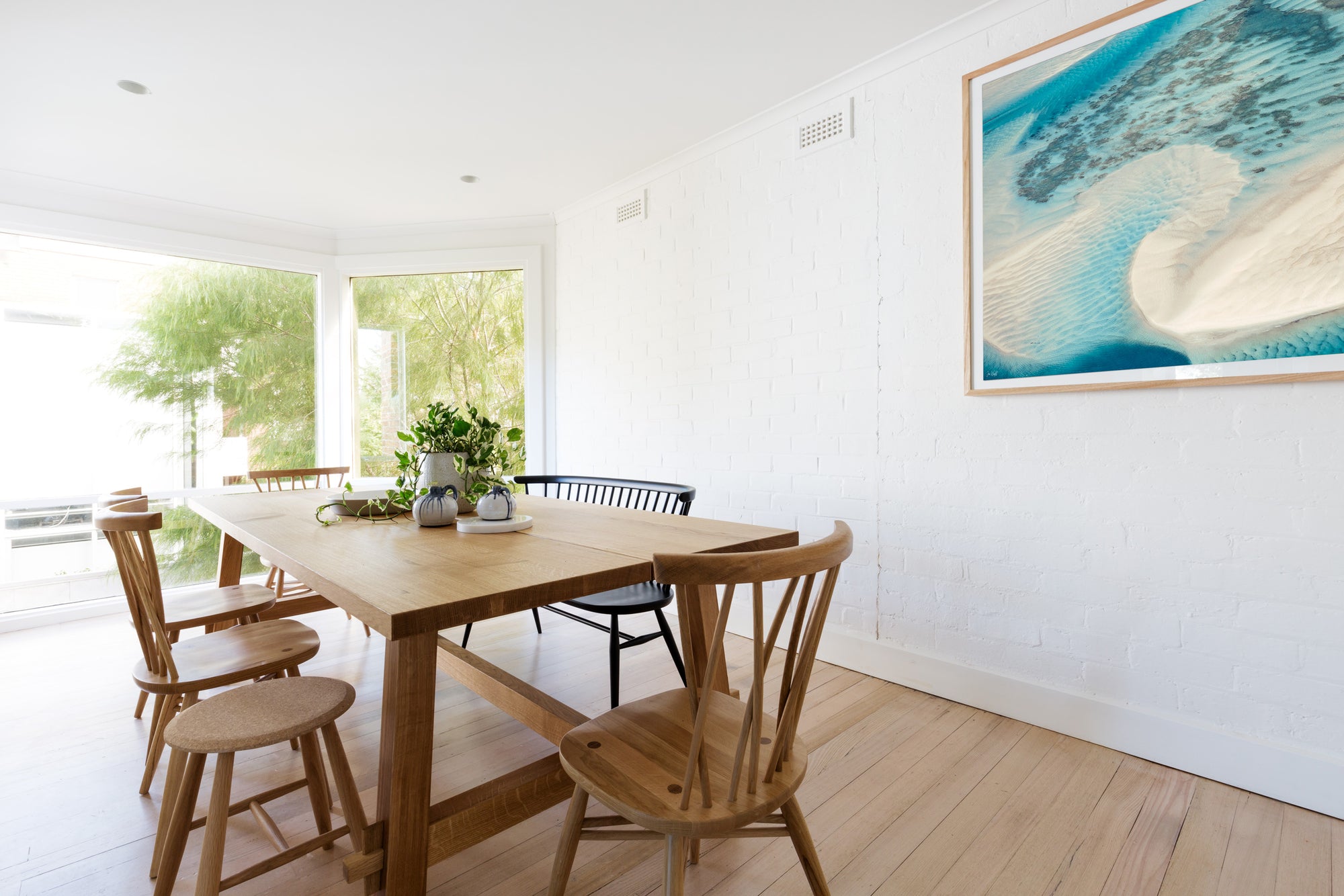 Blue and green wall art in oak frame dinning room