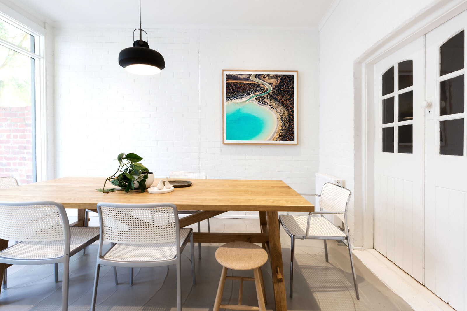 square abstract art hanging on wall with table