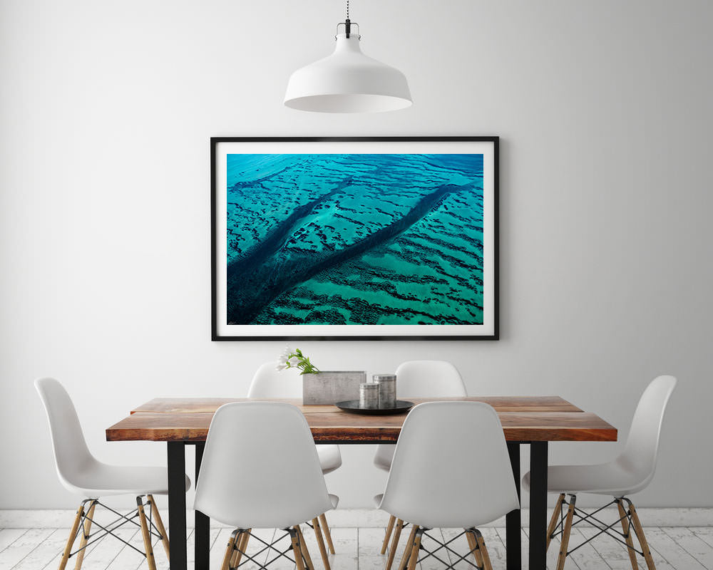 clean modern interior with abstract blue green art in black frame