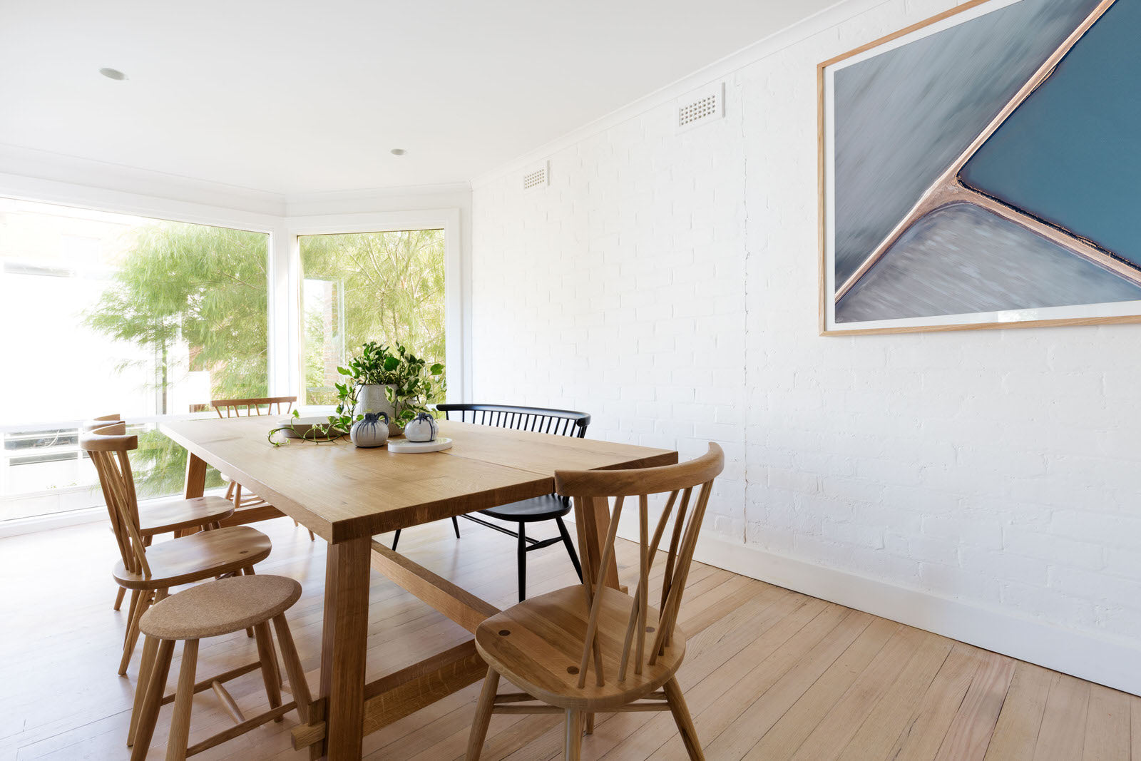 Scandinavian styled room with abstract earthy artwork in oak frame